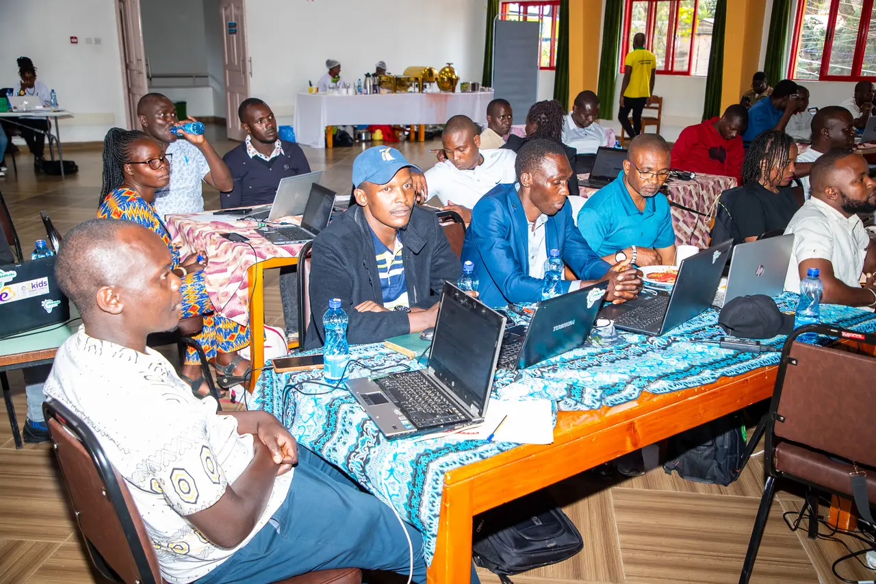 Learners writing code on laptops